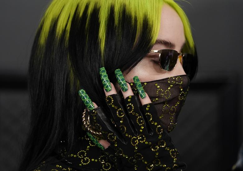Billy Eilish with green hair and green nails.